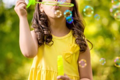 Little girl with soap bubbles